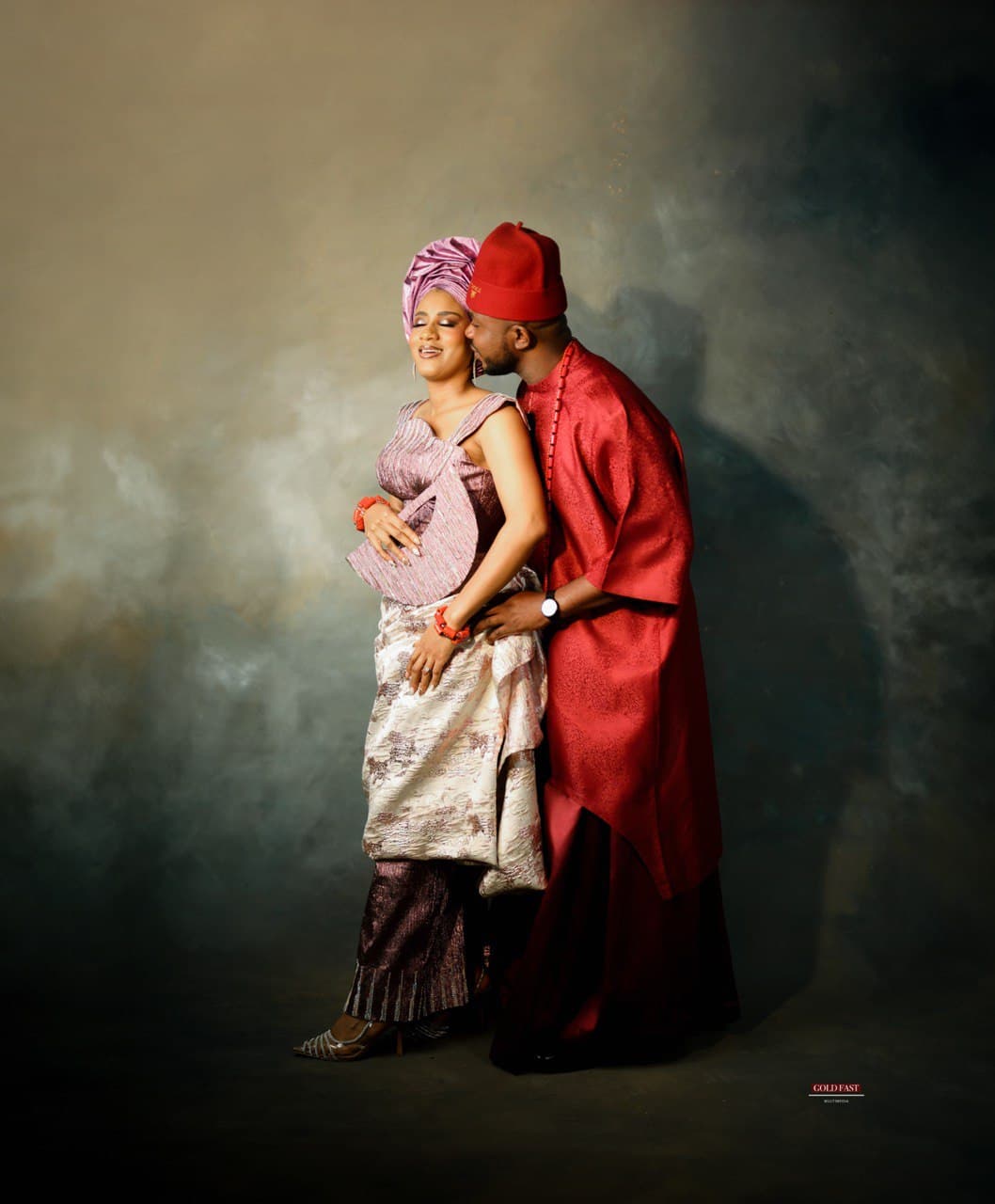 A picture of the bride with her parents.