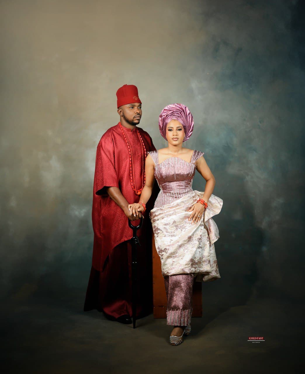 The bride performing the Igbankwu rite, searching for the groom with palm wine.